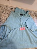 Full view of light blue XXL golf shirt laid flat