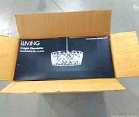Closed cardboard shipping box containing retail chandelier box