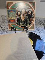 Front cover of Syrinx LP on stand with vinyl partially visible