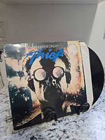 Front sleeve artwork showing Tangerine Dream Thief LP with vinyl partially visible
