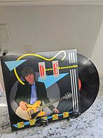 Front jacket and vinyl visible on stand