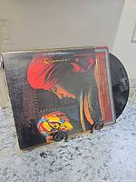 Front cover of the gatefold jacket with vinyl partially visible