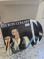 Front cover of Elvis In Concert gatefold with both vinyl discs partially removed