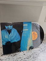 Front cover of George Benson White Rabbit LP on display stand