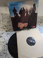 Front album cover and vinyl partially removed in inner sleeve