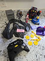 Full lot overview showing Batwing parts, remote, jail cell, turret, launchers, projectiles and figure