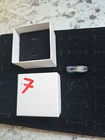 ring and open box on black foam