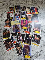 Spread of loose WWF/WWE trading cards on countertop