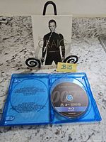 Slipcover front showing Daniel Craig and 007 branding with open case displaying Casino Royale disc