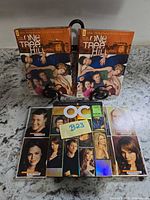 Front view showing two One Tree Hill Season 1 boxes and The OC box