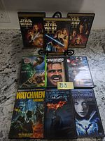 Front view of all nine DVD cases displayed upright showing cover art