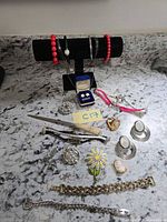 Full group view on countertop showing bracelets on stand and assorted jewelry pieces