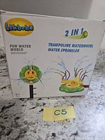 Front of box showing brand, 2-in-1 trampoline waterwhirl water sprinkler info