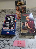 Front view of three VHS movies Taxi Driver, The Razor's Edge, Madame X with slipcases