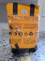 Front view of sealed yellow Kasqo backpack