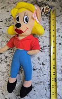 Full view of Pearl Pureheart plush next to tape measure showing 12 in length