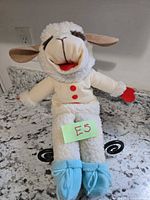 Front view of Lamb Chop puppet showing overall appearance, buttons, booties, facial details