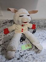 Full view of Lamb Chop puppet seated on countertop showing overall design and size