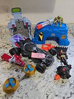 Overall lot showing Batcave parts, vehicles, figures, and accessories