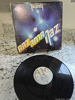 Front jacket and vinyl showing lightning artwork and A&M center label