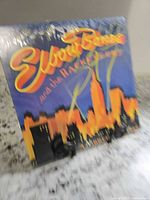 Front cover showing artist name and skyline artwork