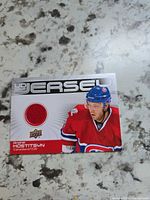 Front of Upper Deck Game Jersey card with player image and red jersey swatch