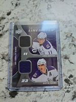 Front of Upper Deck Trilogy Line Mates dual jersey card showing player images and two jersey swatches