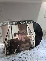 Front cover and vinyl record displayed on stand