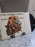 Front cover artwork and vinyl partially visible