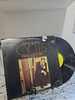 Front sleeve and vinyl record displayed on stand