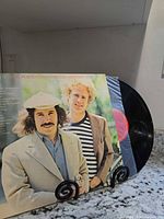 Front cover of Simon & Garfunkel Greatest Hits with record partially visible