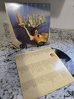 Front cover on stand with lyric sleeve and vinyl record