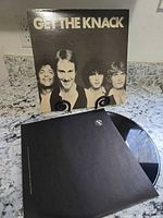 Front of Get The Knack album jacket with black vinyl partially visible in inner sleeve