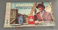 Lid of 1976 Milton Bradley Hangman board game showing title and artwork