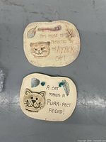 Front view of both ceramic plaques showing designs and text