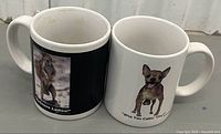 Front view of two printed animal caption ceramic mugs