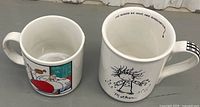 Both mugs side by side showing exterior artwork