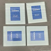 Front view showing all four glass photo coasters with 2" x 3" placeholders