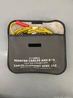 Booster cables inside labelled storage pouch