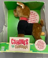 Left side view of plush in original box showing branding