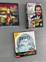 Three boxed games laid out: Phantasmagoria, Dennis Miller Geek, You Don't Know Jack