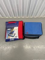 Front view showing red CD binder with 320 capacity sleeve next to blue flap tote