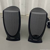 Front view of both Dell speakers showing grey grilles and Dell branding