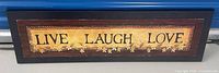 Front view of rectangular plaque showing LIVE LAUGH LOVE text and floral design