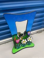 Front view of mirror showing painted flower and bee decorations