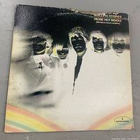 Front cover of Rolling Stones More Hot Rocks album showing title and edge damage