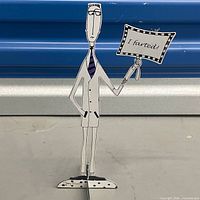 Front of metal figure showing I farted! sign and overall design