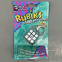 Front view showing sealed Rubik's Cube key ring on blister card