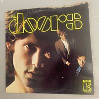 front album cover with yellow logo and band photo