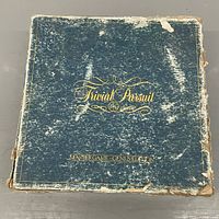 Worn blue box lid showing Trivial Pursuit Master Game Genus Edition text